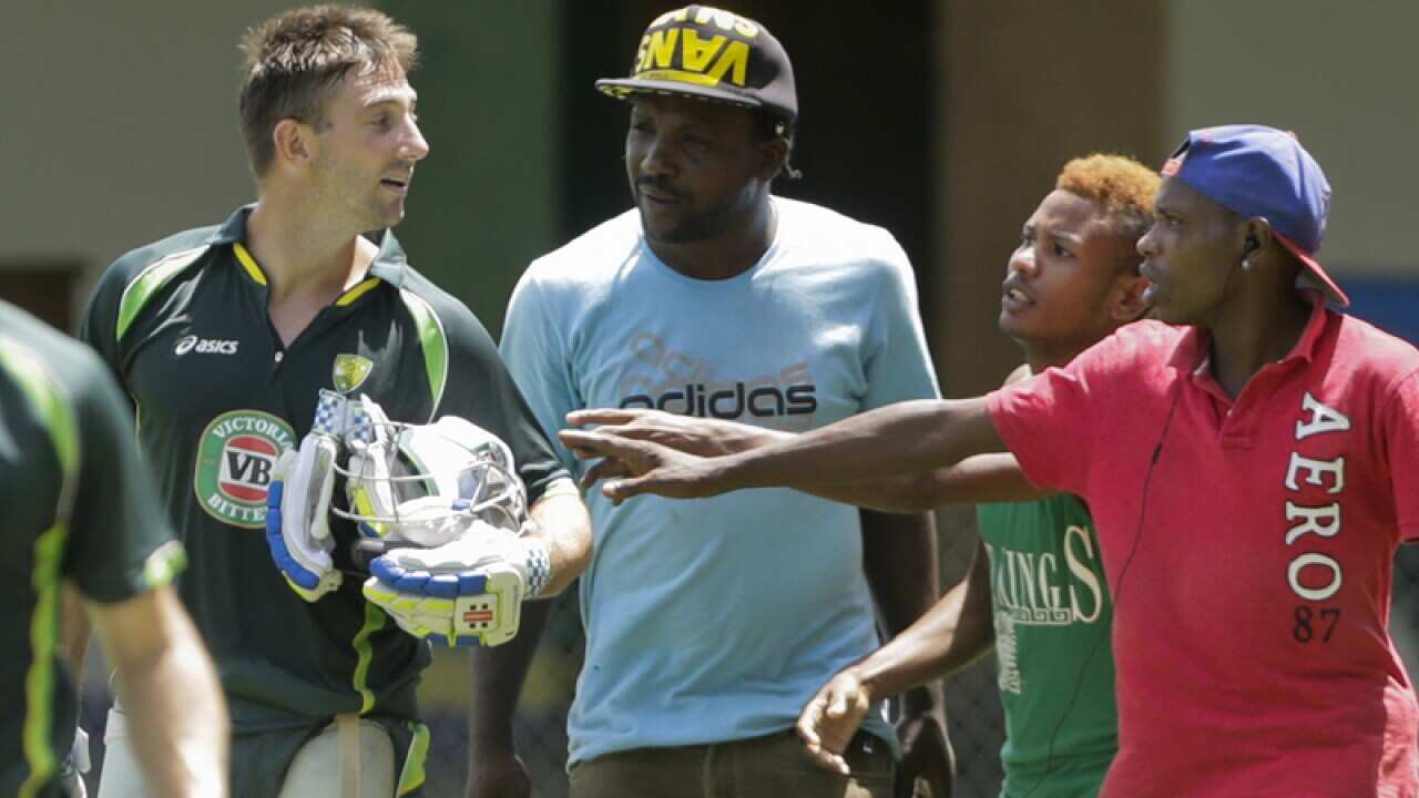 Australia's Shaun Marsh, left, talks with park workers.
