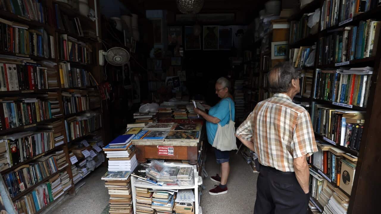 People inside a bookstore without electricity in Havana, Cuba.