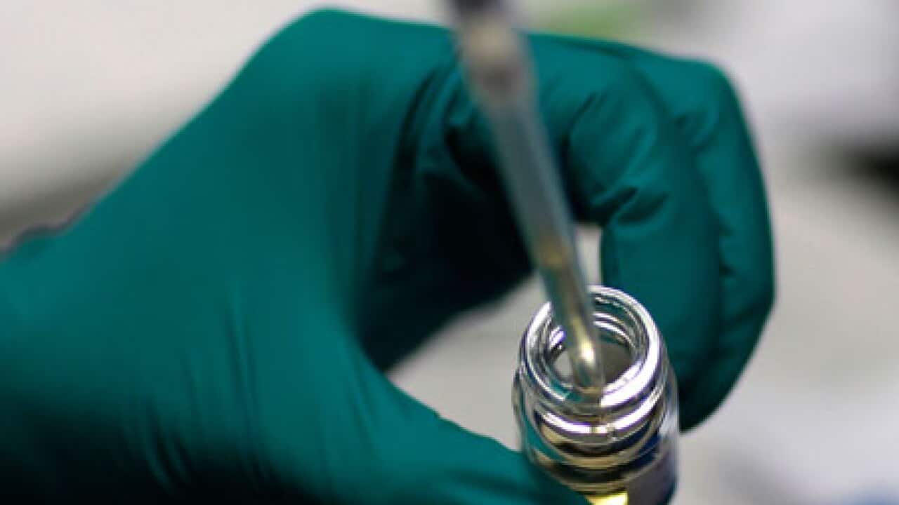 A syringe going into a vaccination tube