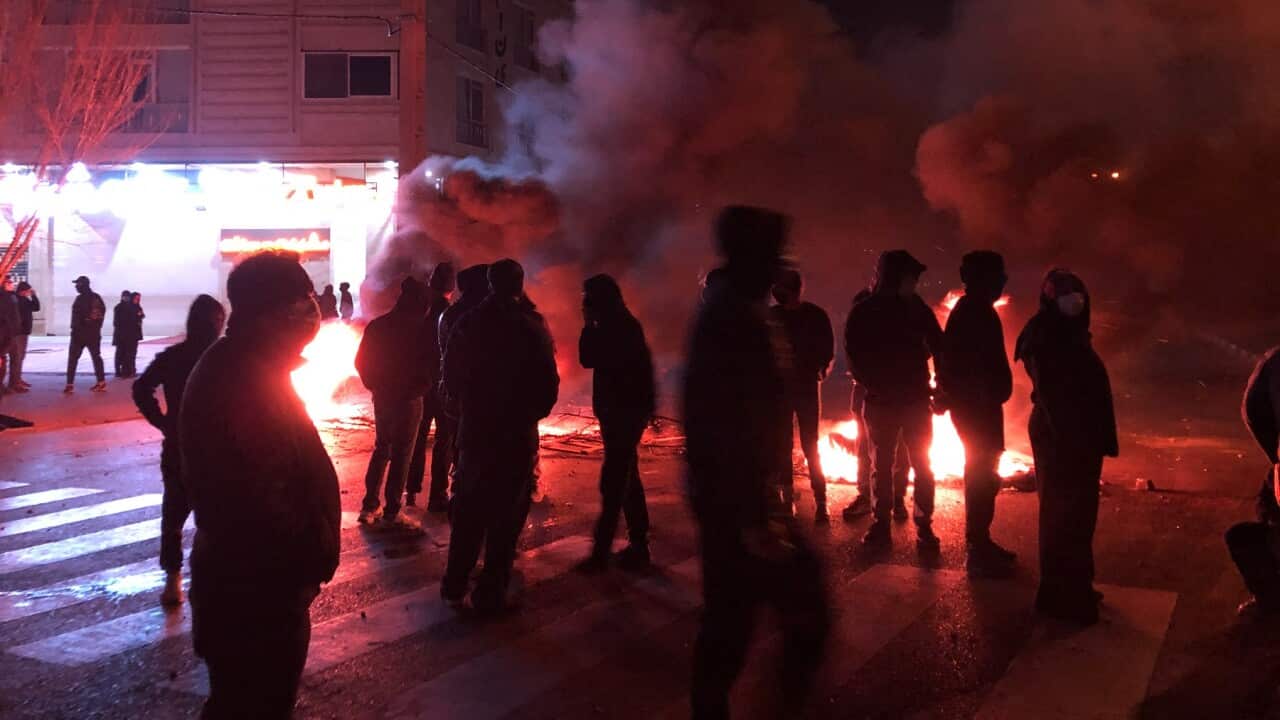 Iranian protesters block a street and set a fire during a demonstration in Shiraz, Iran (AAP)