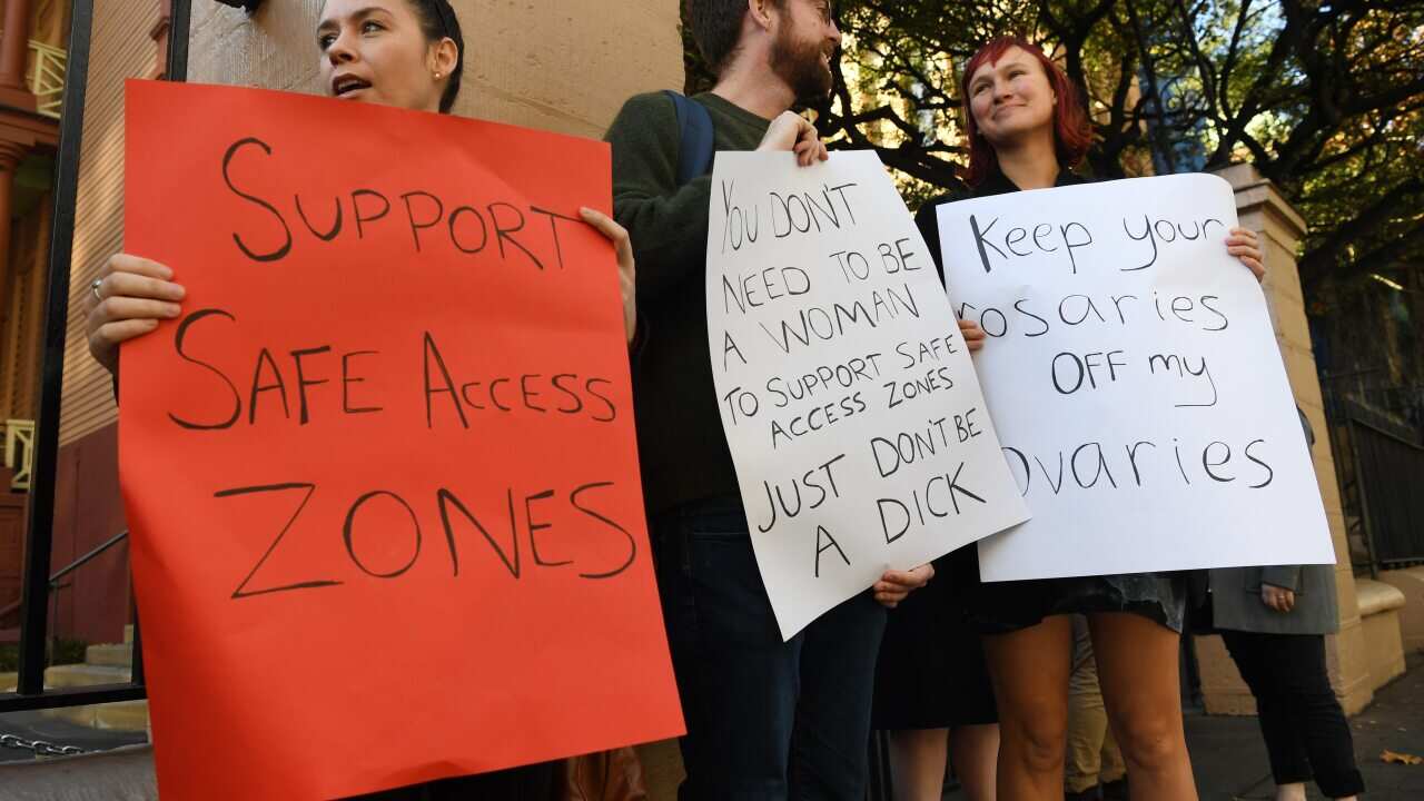 Demonstrators calling for safe access zones around abortion clinics stand outside the NSW State Parliament.