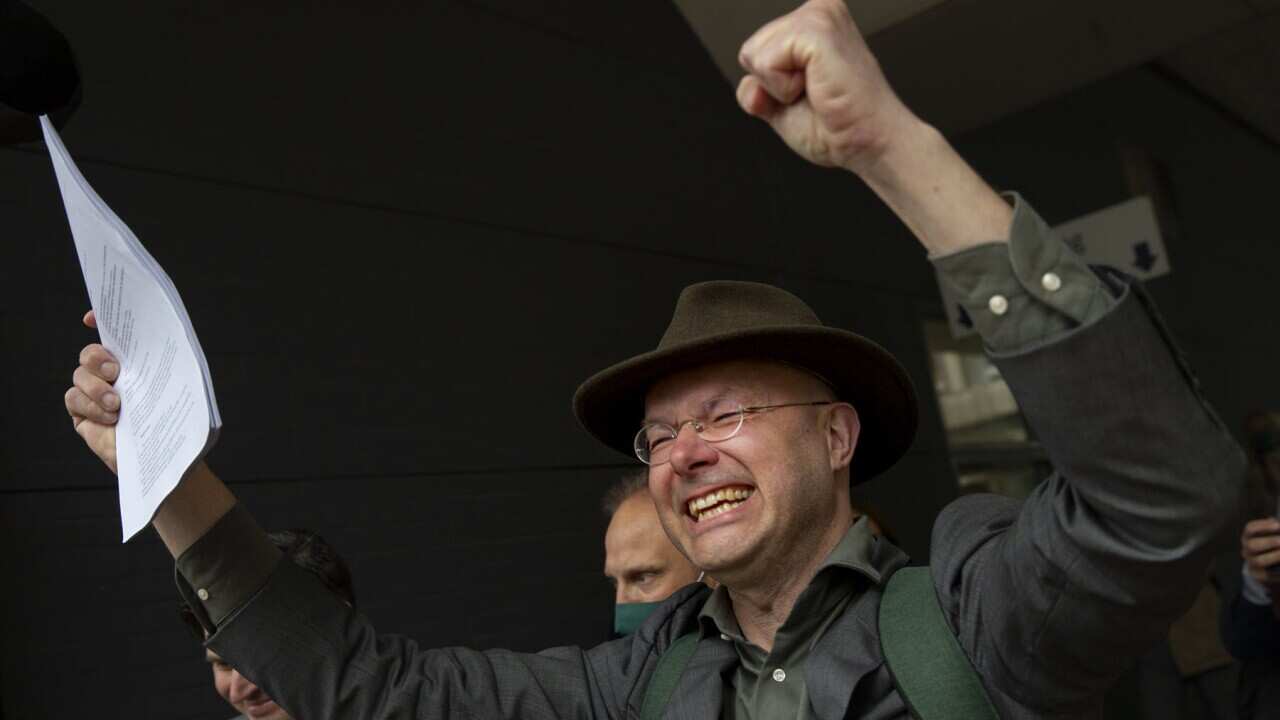 A campaigner celebrates the Dutch court ruling
