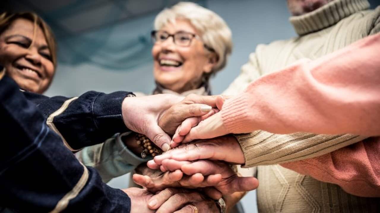 Group of seniors making activities inside the hospice