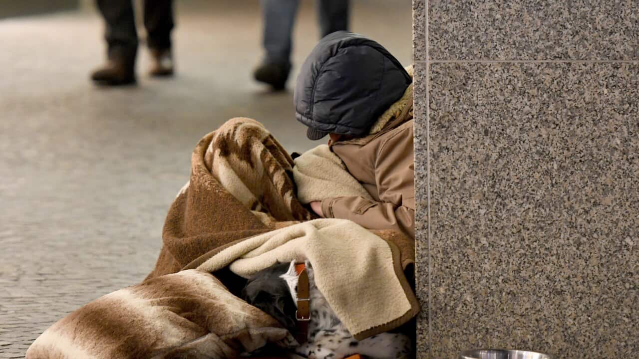 A homeless man sleeping in the street