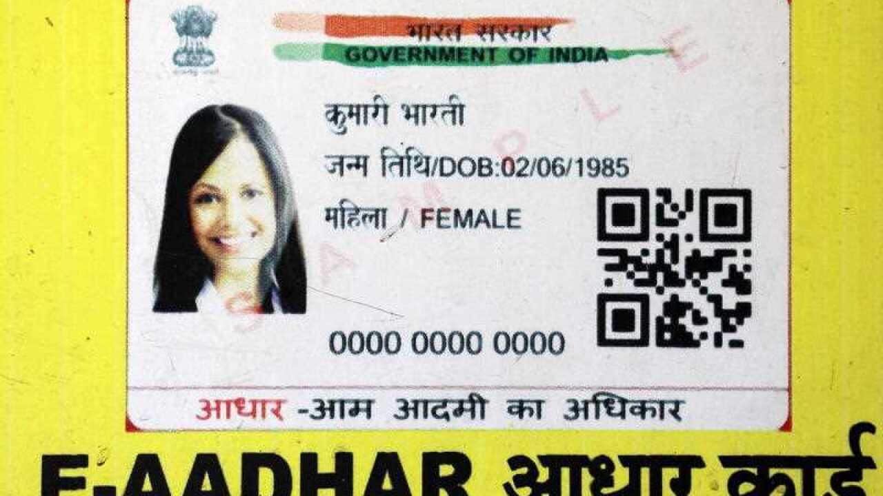 A close up view of a sample of an Aadhaar card.