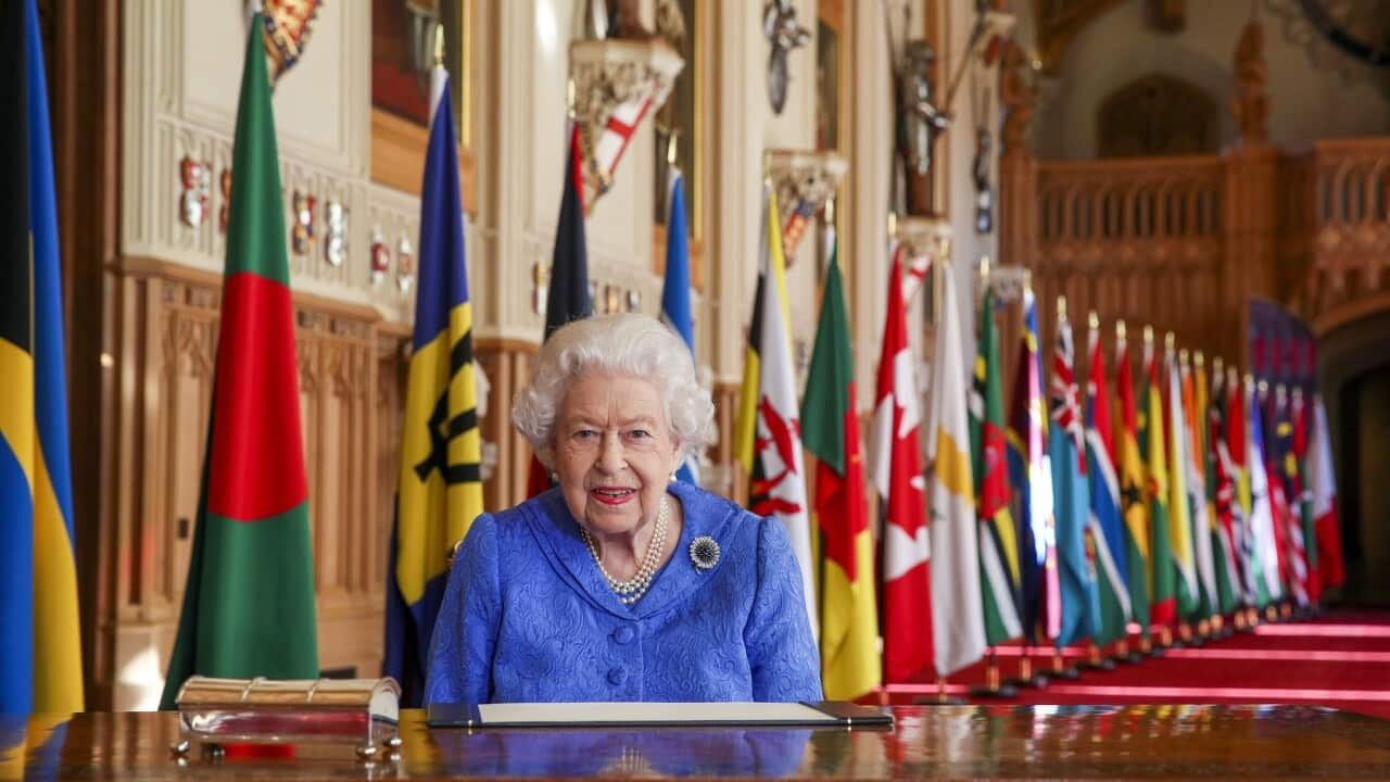 In this photo made available Sunday March 7, 2021, Britain's Queen Elizabeth II poses for a photo while signing her annual Commonwealth Day Message inside St George's Hall at Windsor Castle, England, Friday March 5, 2021. (Steve Parsons/Pool via AP)