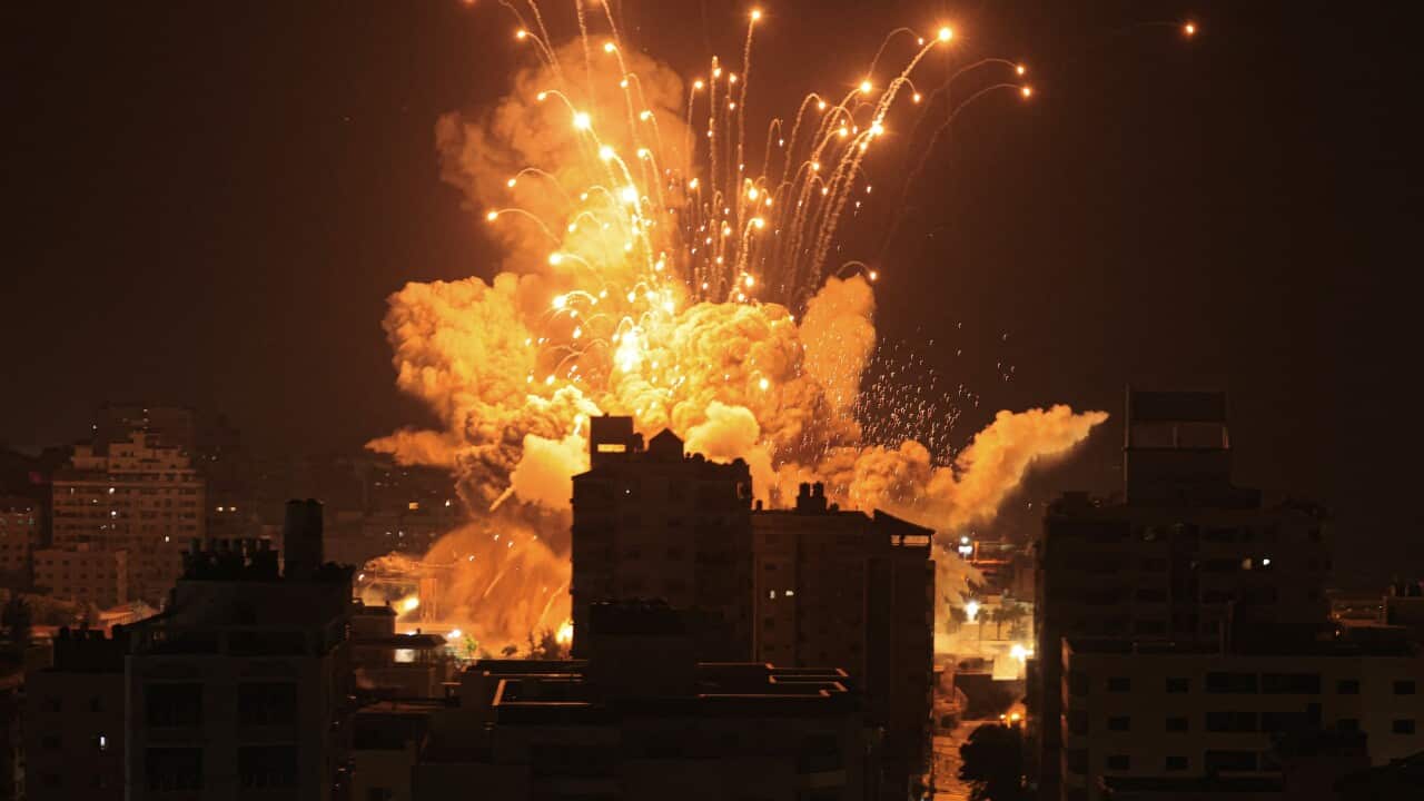 A missile exploding above a city skyline.
