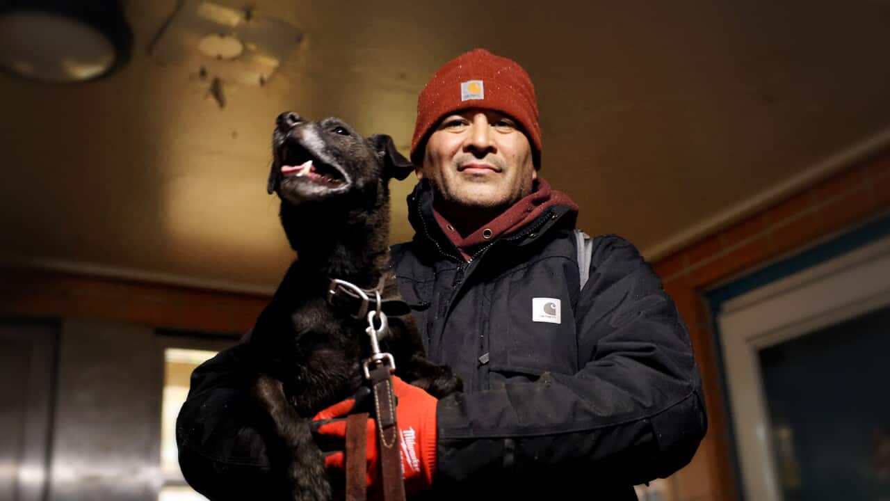 A man holding his dog
