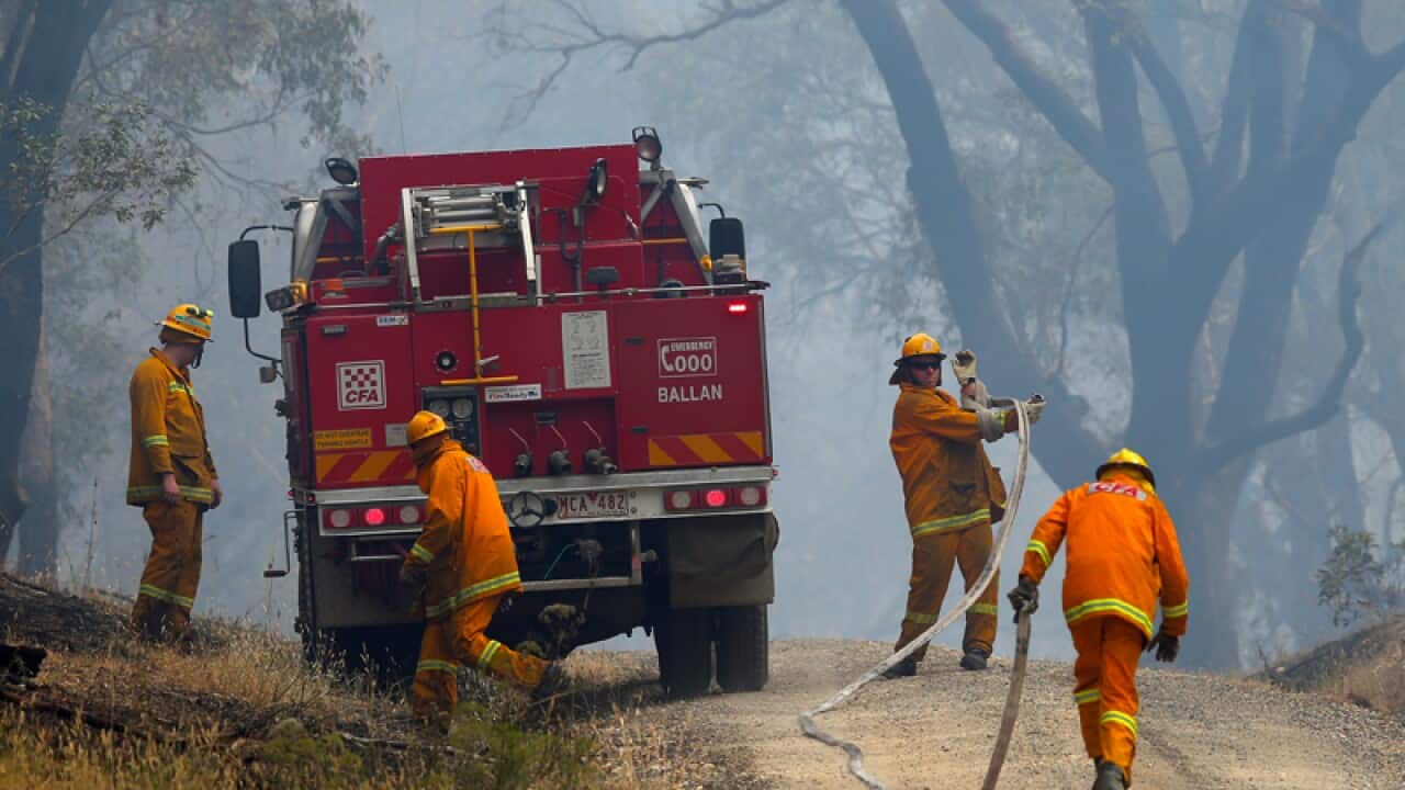 Firefighters work to contain a bushfire near Scotsburn