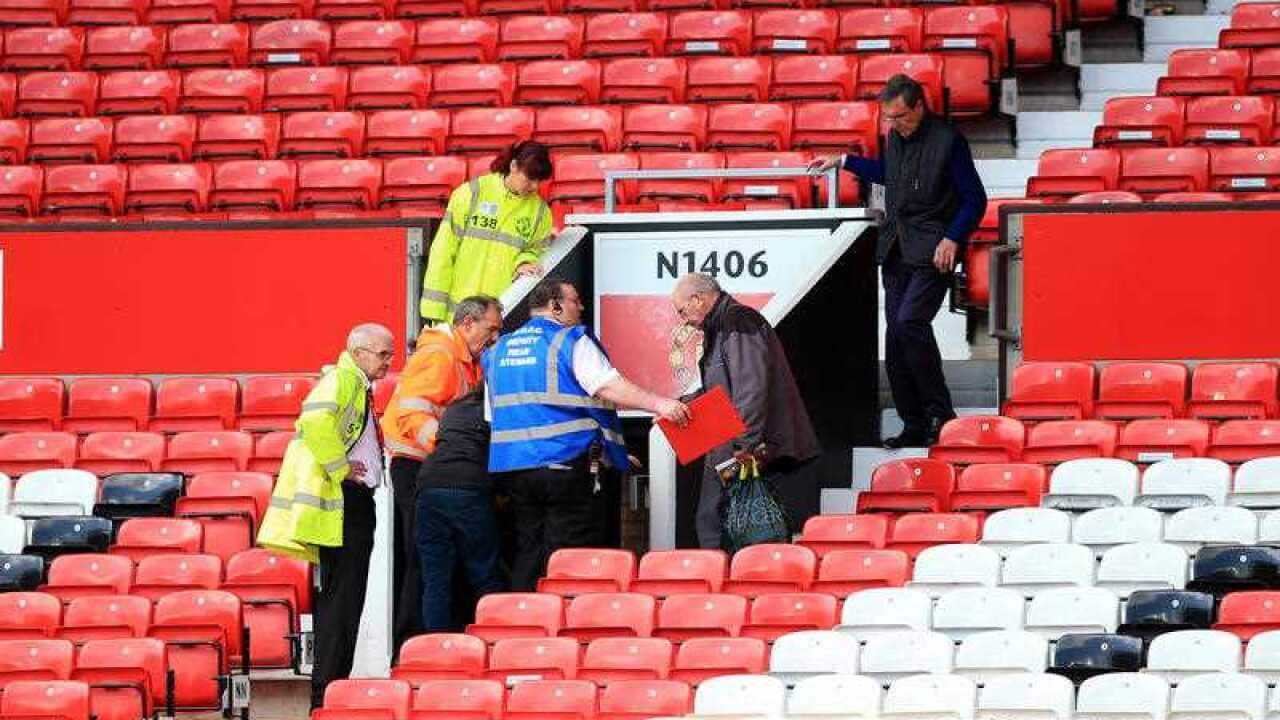 Manchester United fans leave the ground following a security announcement.