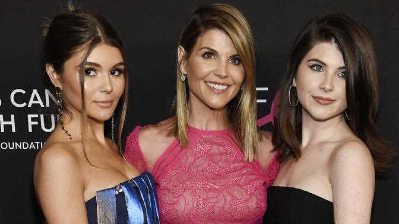 Actress Lori Loughlin, center, poses with daughters Olivia Jade Giannulli, left, and Isabella Rose Giannulli.