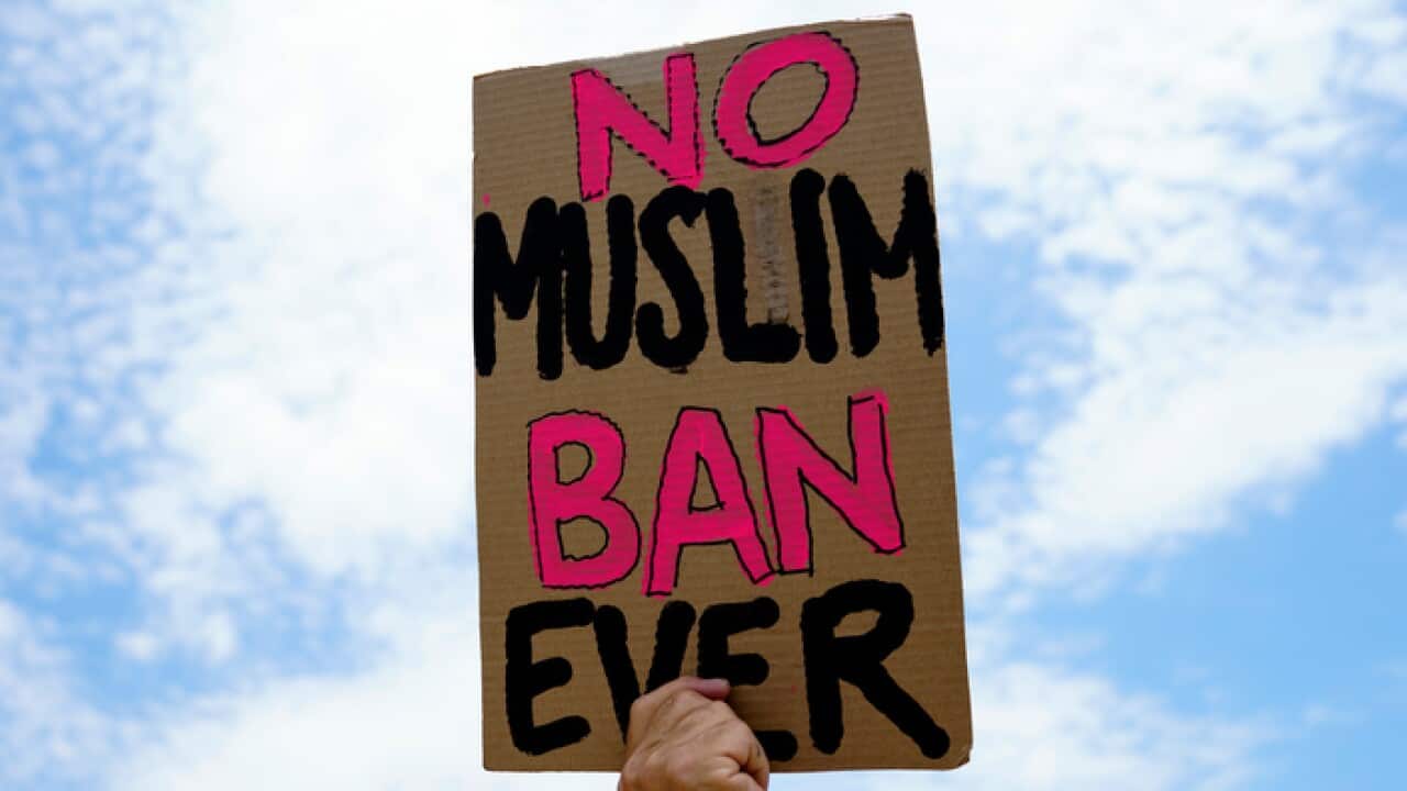 A protester holds up a sign that reads "No Muslim Ban Ever" as he protests against the Supreme Court ruling upholding President Donald Trump's travel ban outside the the Supreme Court in Washington, Tuesday, June 26, 2018. (AP Photo/Carolyn Kaster)