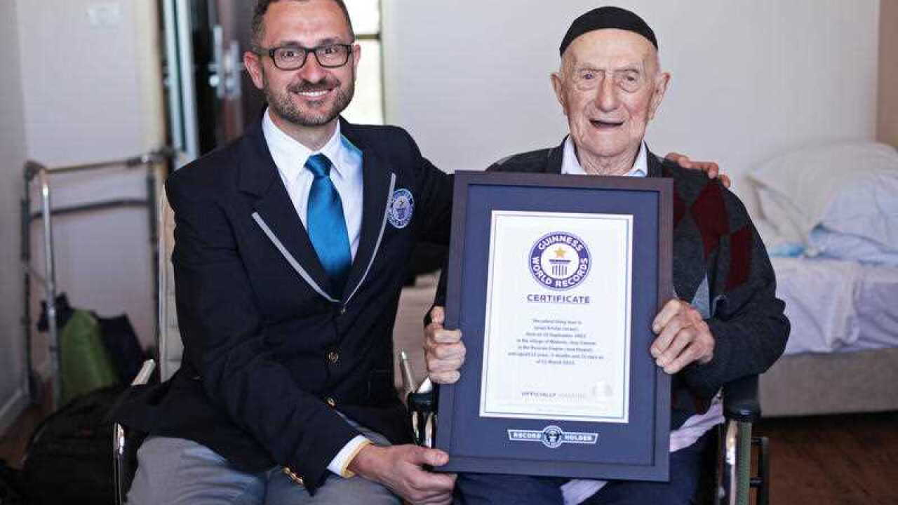 Marco Frigatti, Head of Records for Guinness World Records presents Israel Kristal a certificate for being the oldest living man, in Haifa, Israel.
