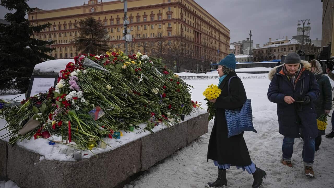 People in Moscow lay flowers honouring Alexei Navalny at a monument to the Gulag political prison system