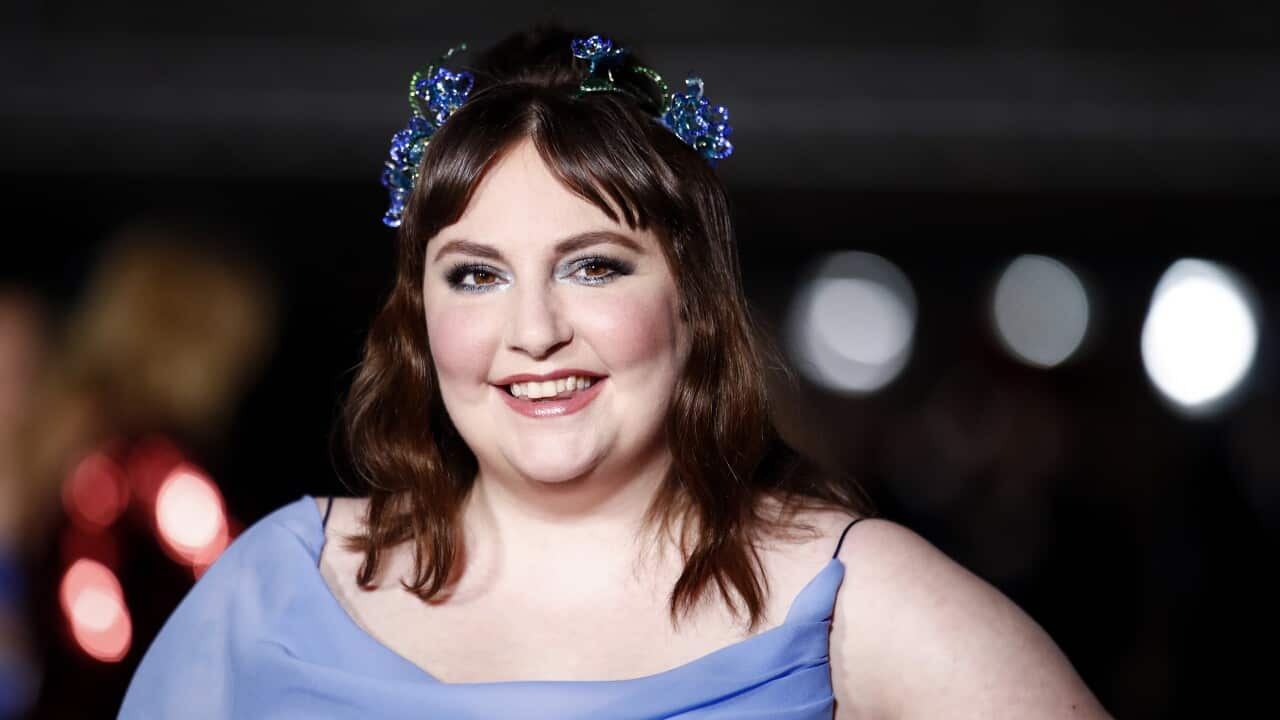 A woman in a purple dress and butterfly crown