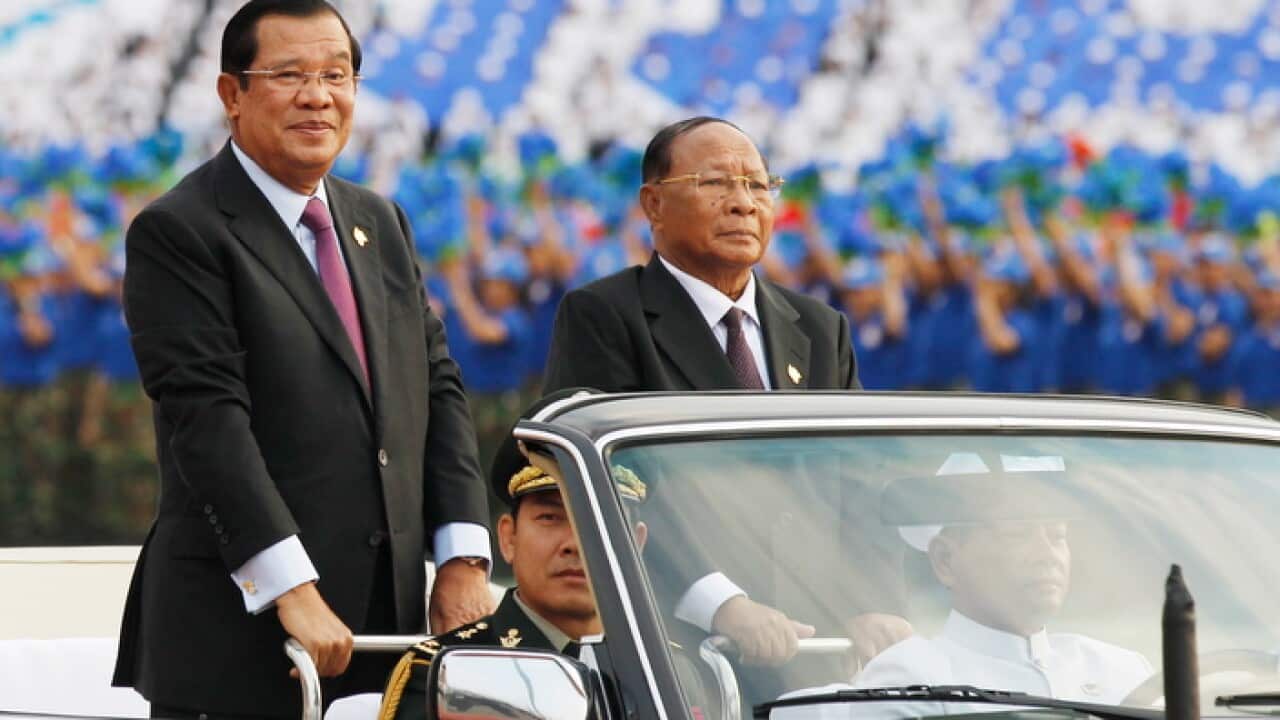Cambodian Prime Minister Hun Sen (L), during a ceremony for Victory Day at the Olympic National Stadium in Phnom Penh