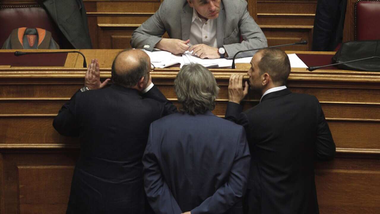 Greek Finance Minister Euclid Tsakalotos talks with lawmakers
