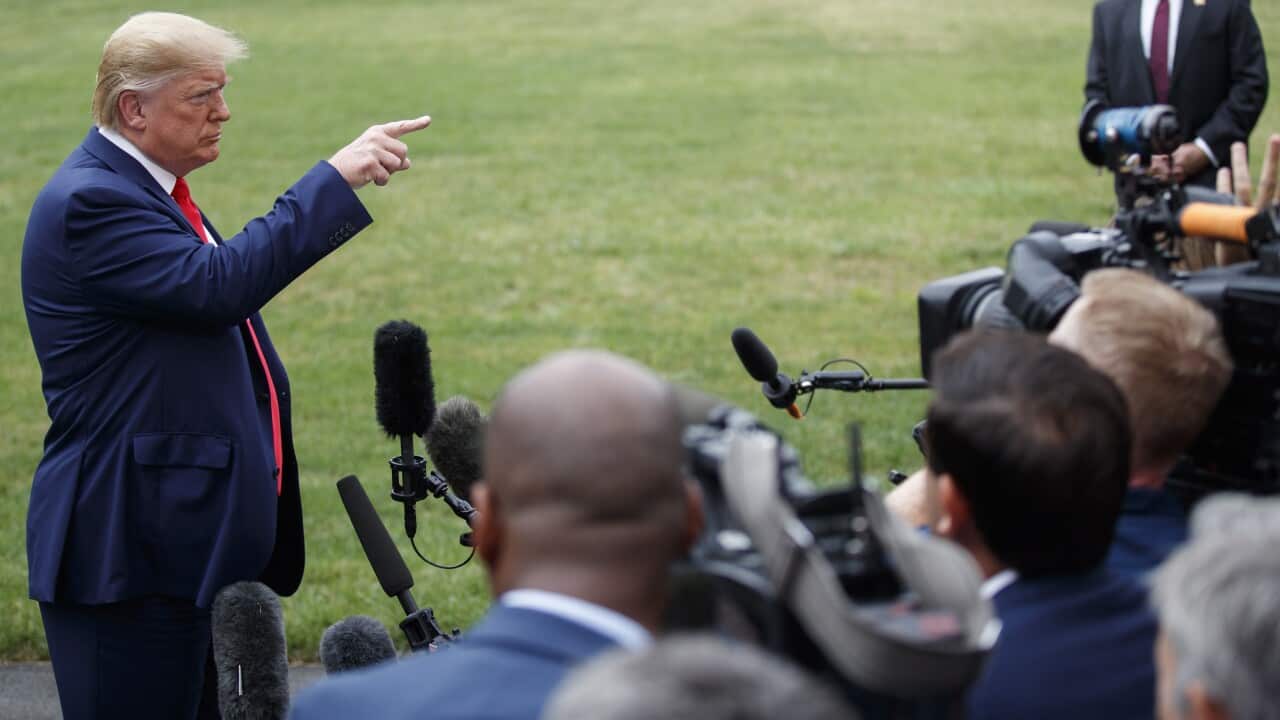 US President Donald Trump responds to a question from the news media as he walks to board Marine One on the South Lawn of the White House in Washington.