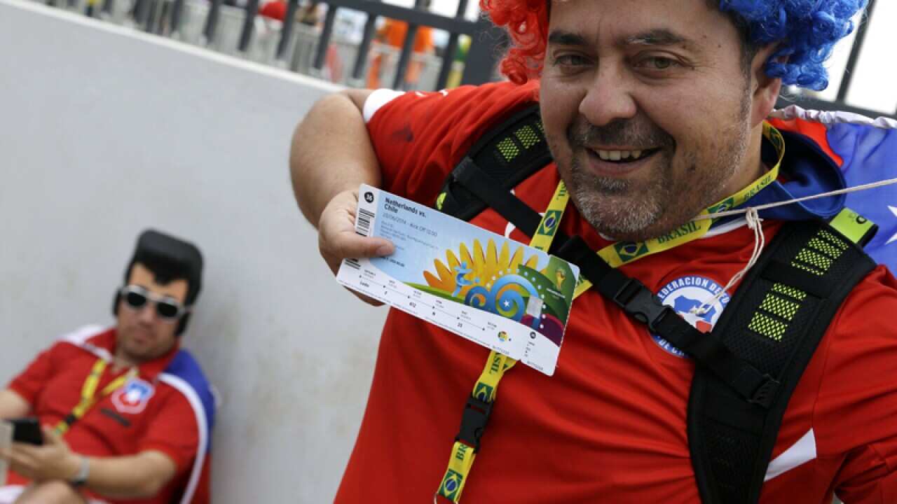 A Chilean fan shows his World Cup ticket
