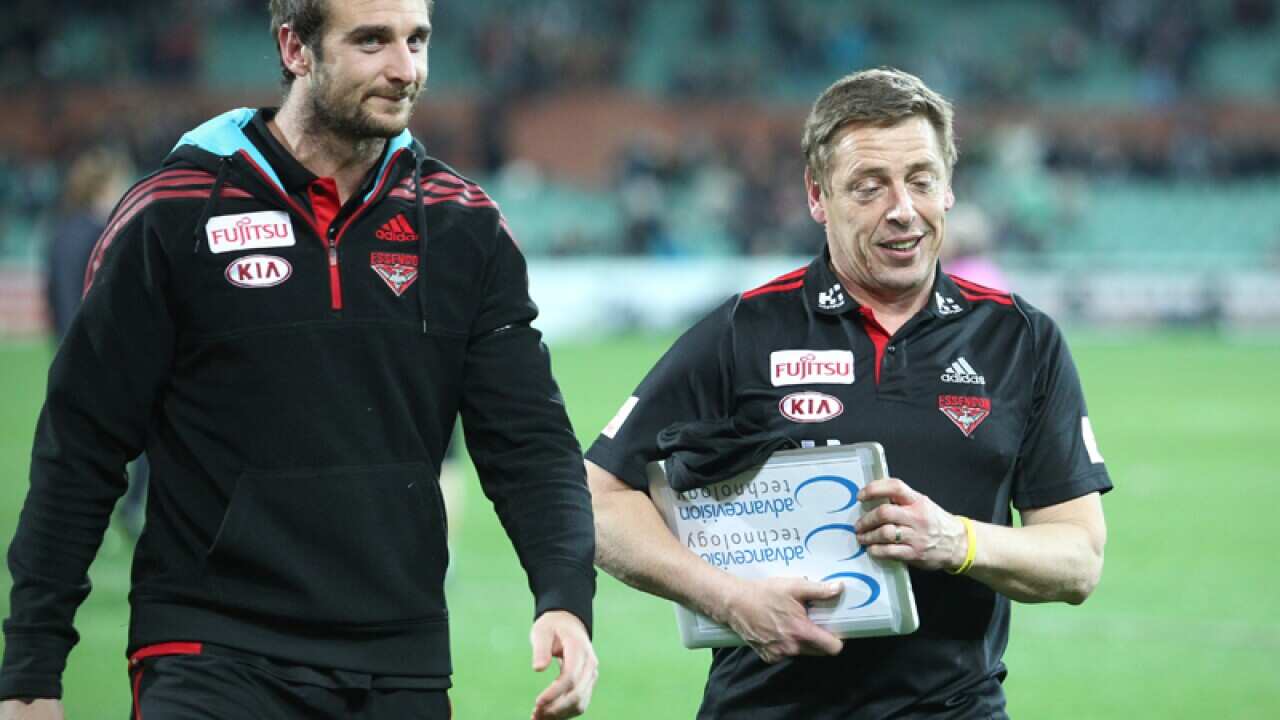 Essendon captain Jobe Watson speaks with coach Mark Thompson.