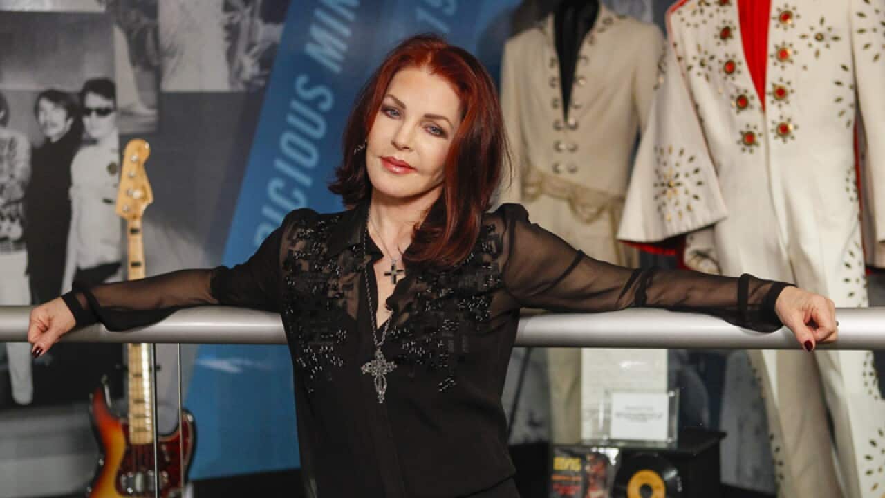 Priscilla Presley stands in the "60 years of Elvis" exhibit