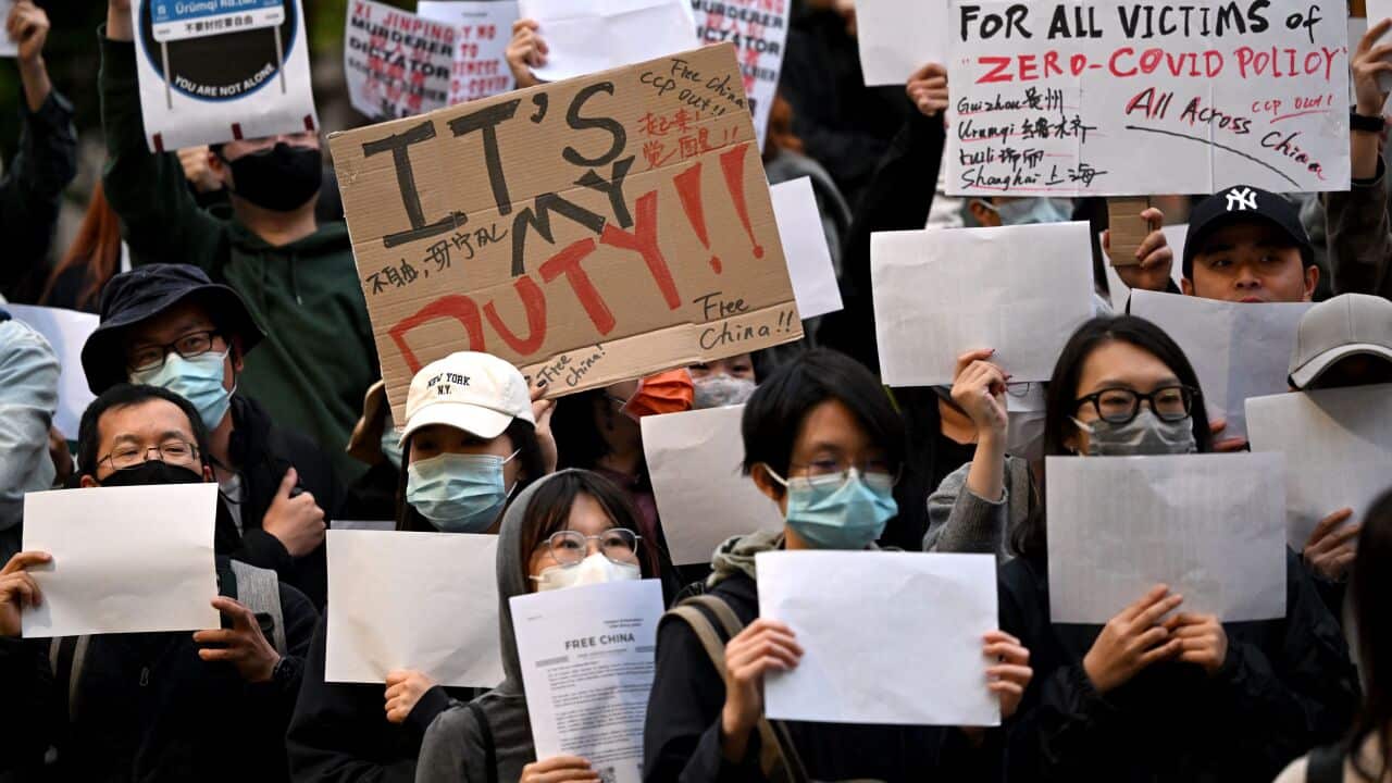 Protesters holding signs.