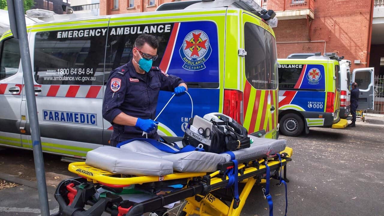 A paramedic moves equipment outside St. Vincent's Hospital in Melbourne as a Code Brown is declared