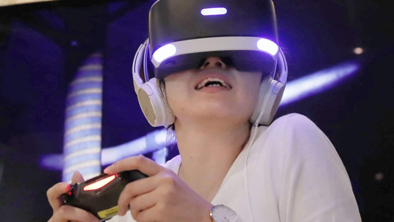 A woman wears a PlayStation VR headset