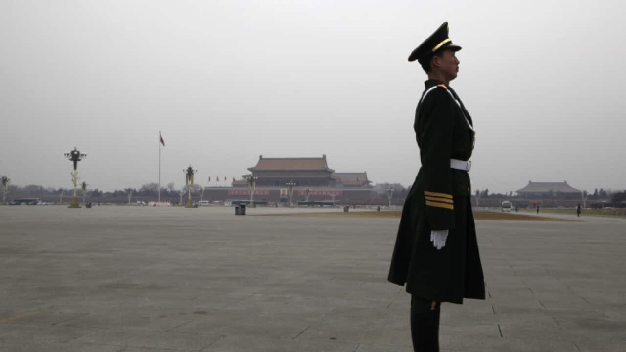 A paramilitary policeman stands guard on Tiananmen Square ahead of the fourth plenary meeting of China's parliament, the National People's Congress (NPC), in Beijing March 11, 2010. REUTERS/David Gray (CHINA - Tags: MILITARY POLITICS) - RTR2BHM8