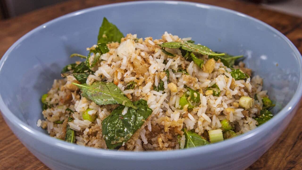A rice and herb salad sits in a blue bowl.