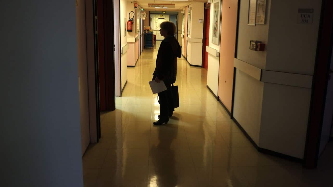 Person stands in dark corridor