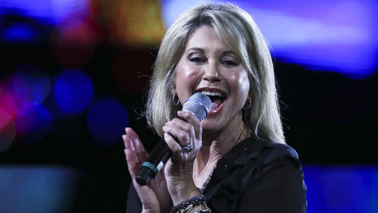 A woman singing into a microphone