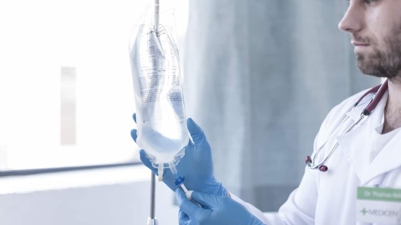 Nurse adjusting intravenous drip