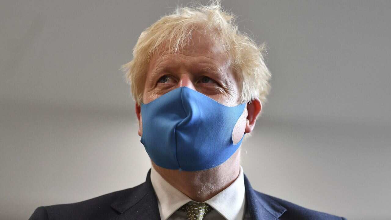 Britain's Prime Minister Boris Johnson, wearing a face mask, visits the headquarters of the London Ambulance Service NHS Trust in London, Monday July 13, 2020. (Ben Stansall/Pool via AP)