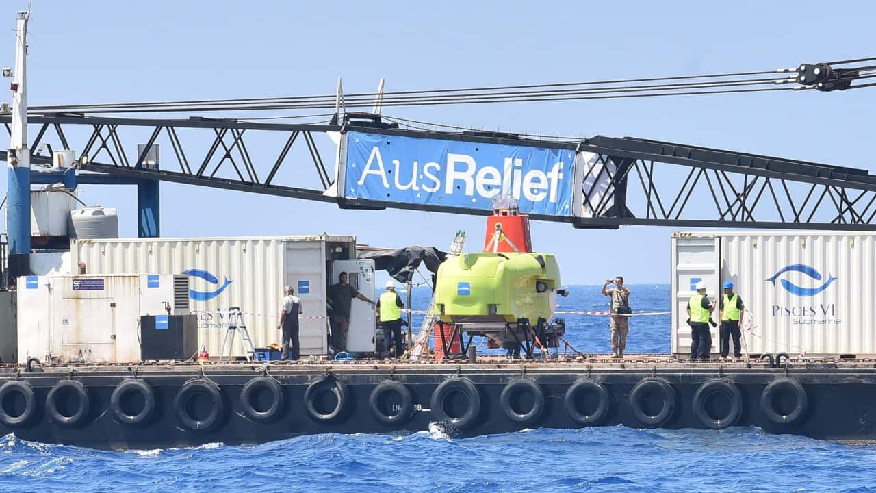 Personnel prepare to launch the submarine to find and salvage the wreckage of a boat that capsized carrying illegal migrants off Tripoli