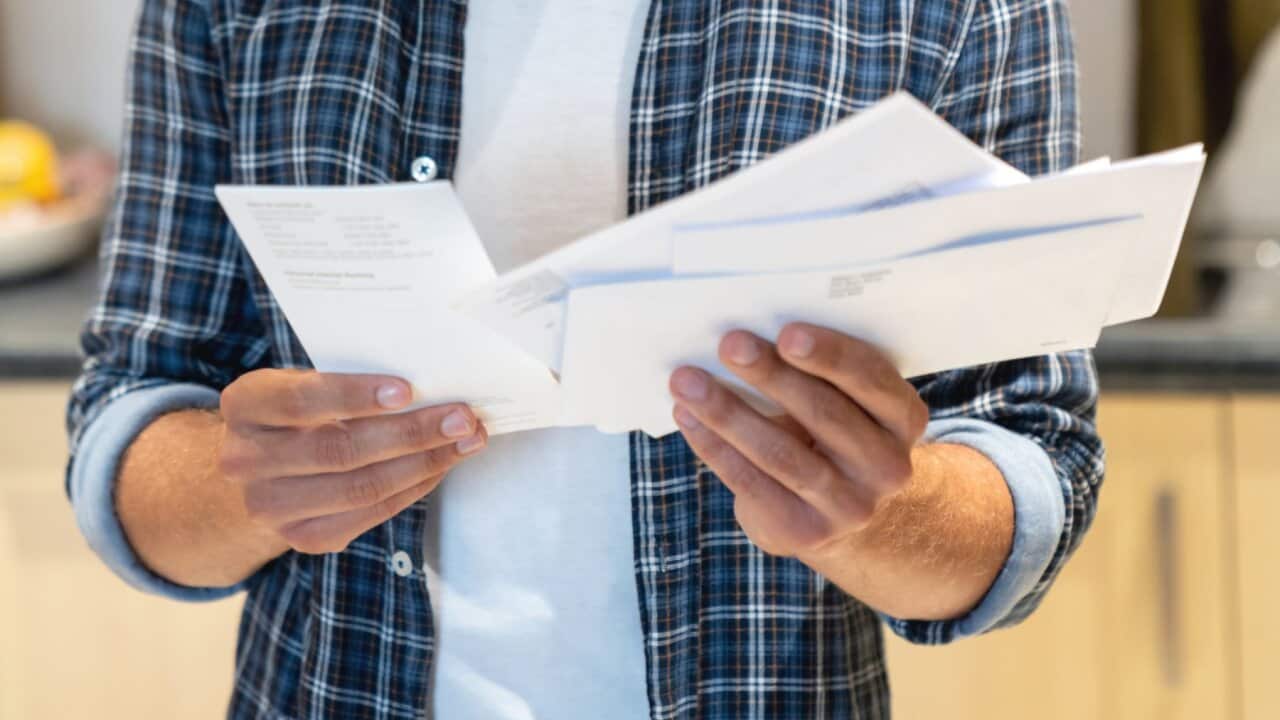 Young man at home checking his mail