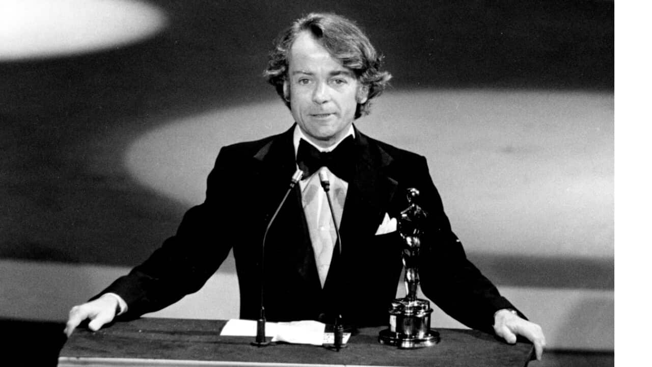 In this March 28, 1977, file photo, John G. Avildsen accepts the Oscar for best director for "Rocky" at the Academy Awards in Los Angeles