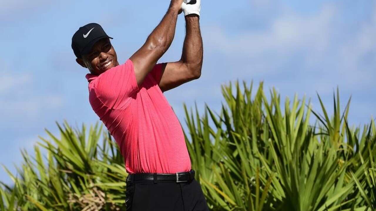 Tiger Woods tees off on the third hole