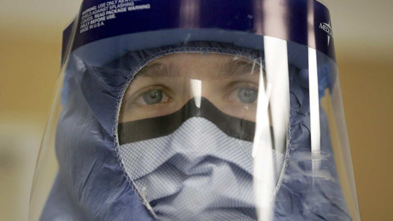 A healthcare worker in protective clothing.