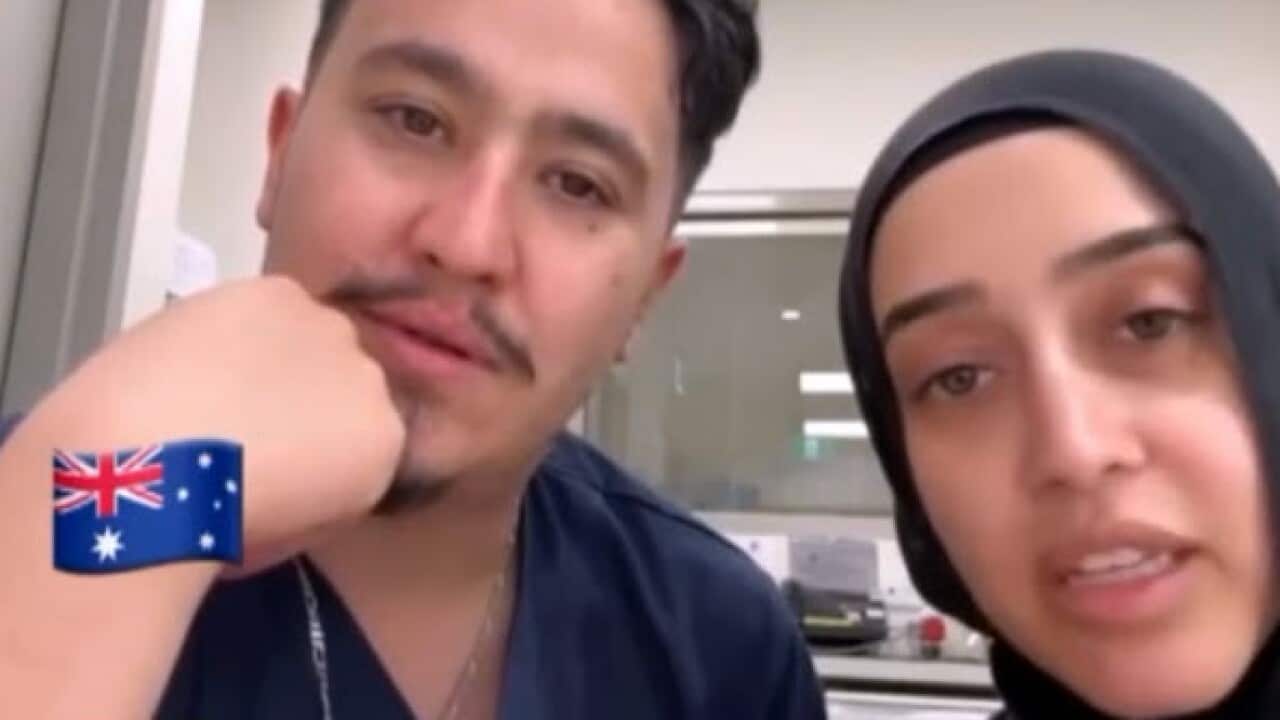 A man and a woman looking at the camera