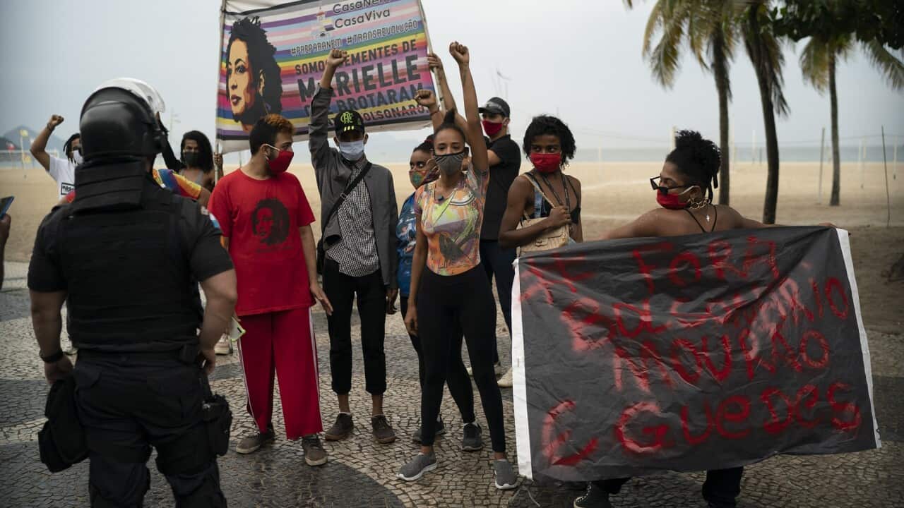 A small group of people protest against Brazil's President Jair Bolsonaro at Copacabana
