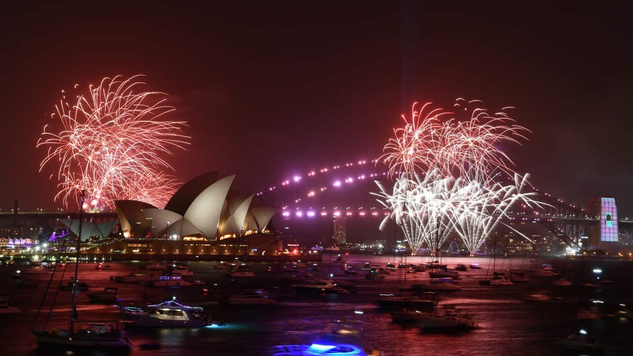Los fuegos artificiales iluminan el cielo nocturno sobre el puente de la bahía de Sídney.