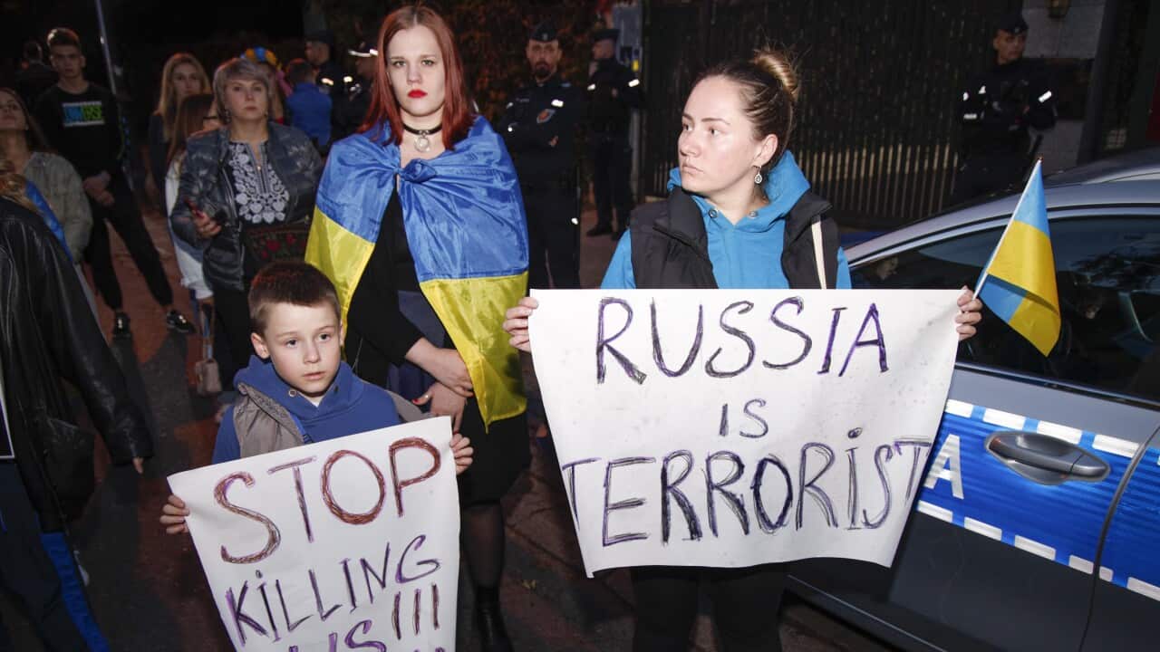 A woman and a child are seen holding signs during a protest in Warsaw, Poland on 17 October, 2022.