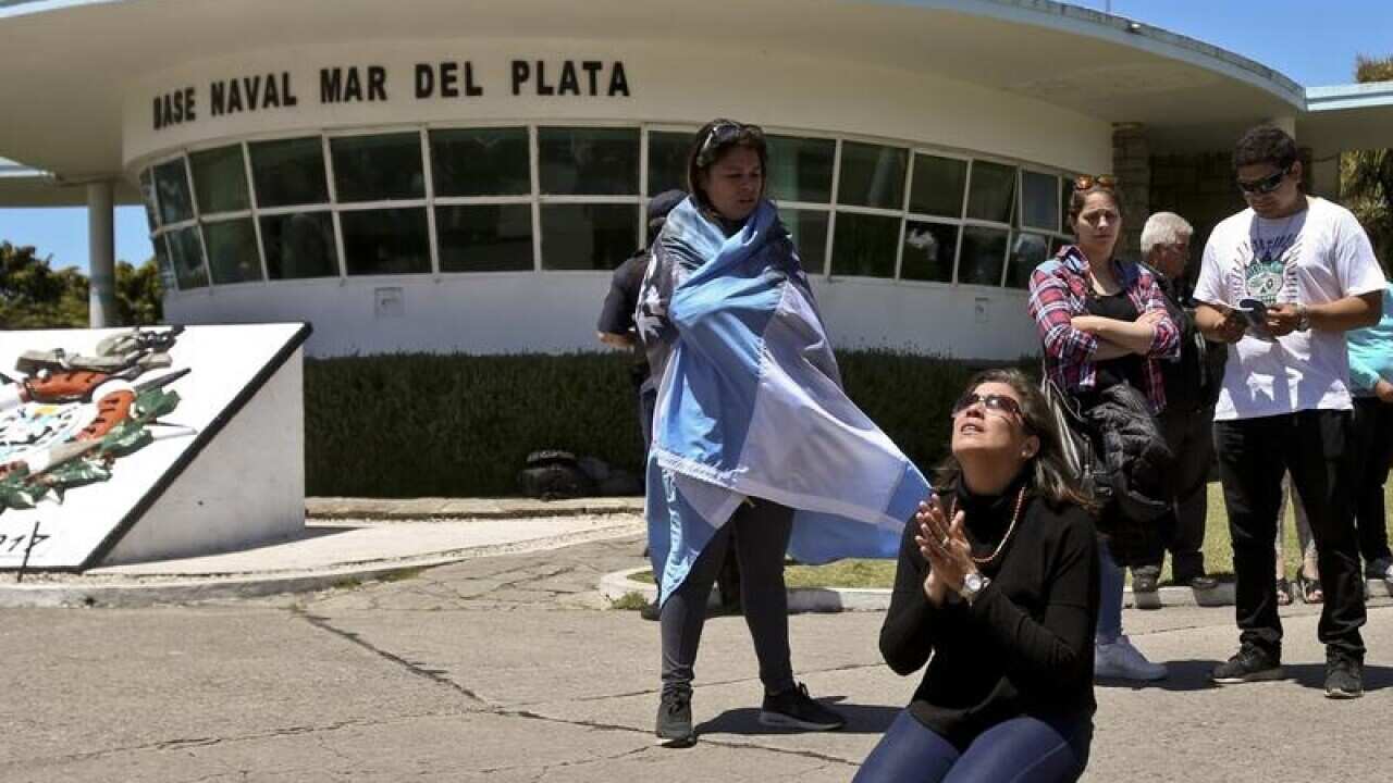 A relative of missing Argentine submarine crew member prays