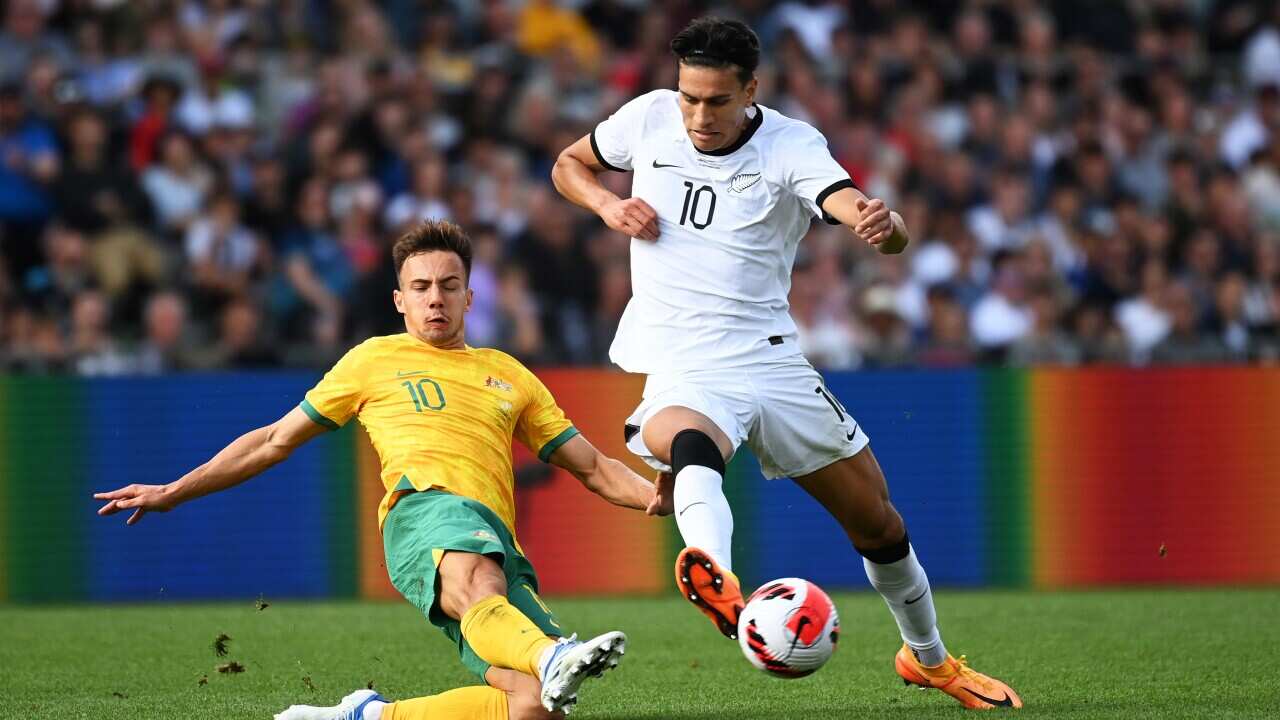 Marko Stamenic of New Zealand (right) competes for the ball with Deni Genreau of Australia during the friendly match between New Zealand and Australia in Auckland