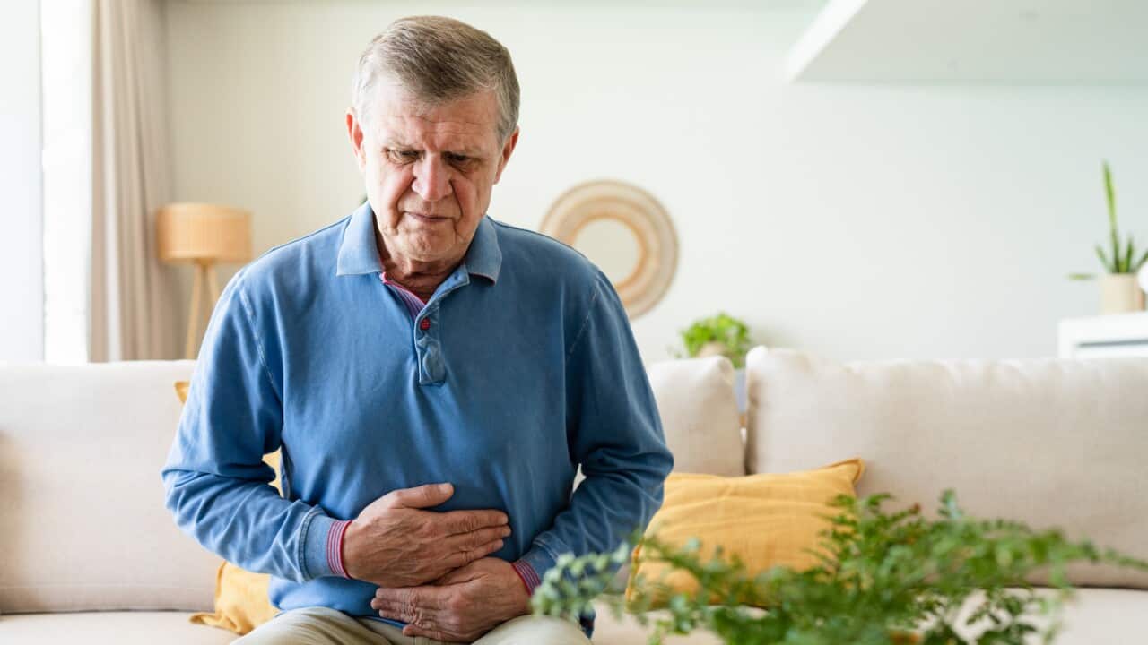 Senior man suffering stomach pain at home