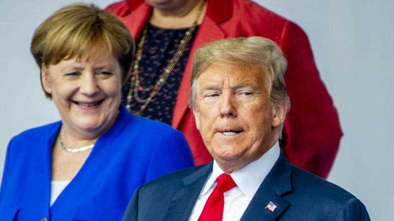 German Chancellor Angela Merkel, President Donald J. Trump stand together as they gather for a family picture during a NATO summit in Brussels, Belgium, July 11, 2018.