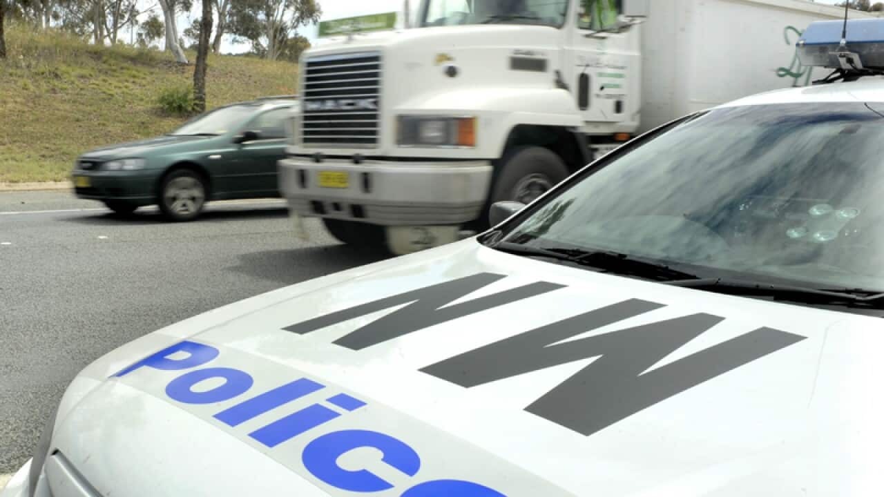 A police car monitors traffic