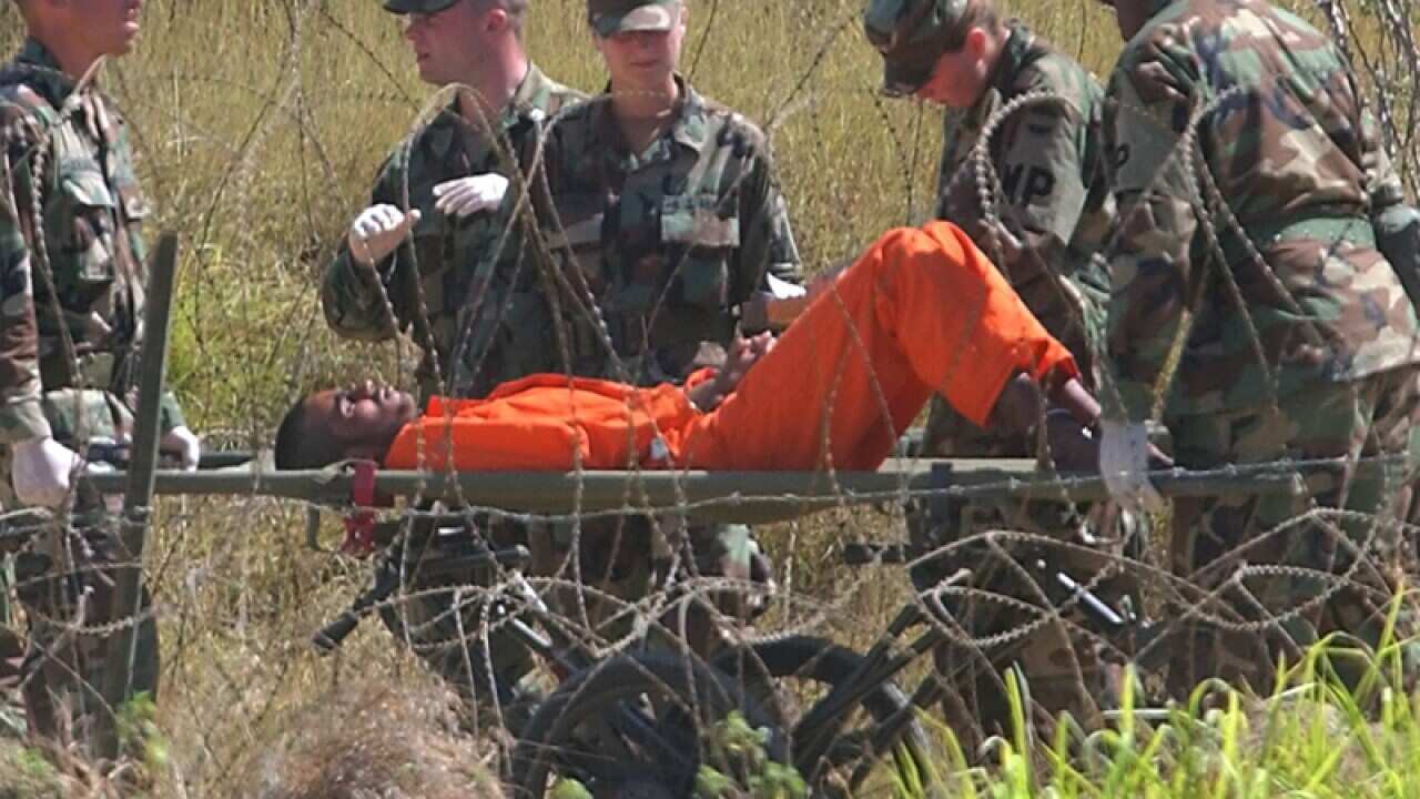 A detainee is carried at the U.S. Naval Base in Guantanamo Bay