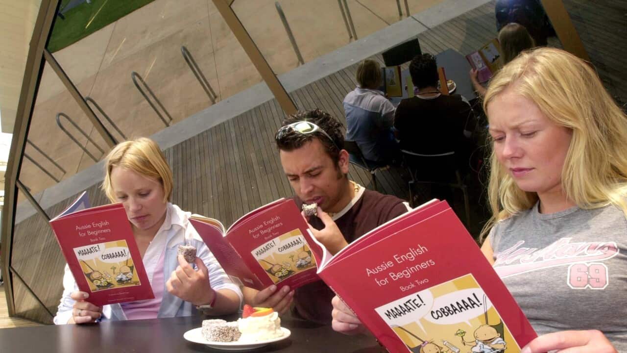 Three people eating and reading books